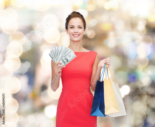smiling elegant woman in dress with shopping bags