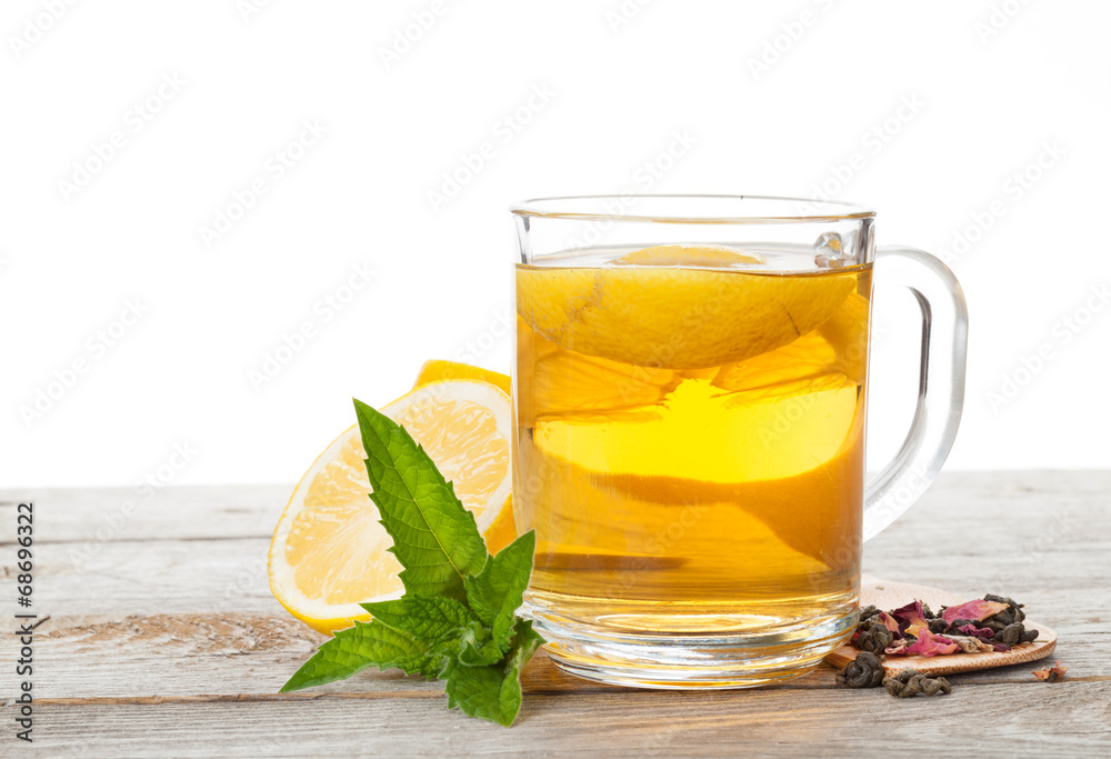 Green tea with lemon and mint on wooden table Green tea with lemon and mint on wooden table