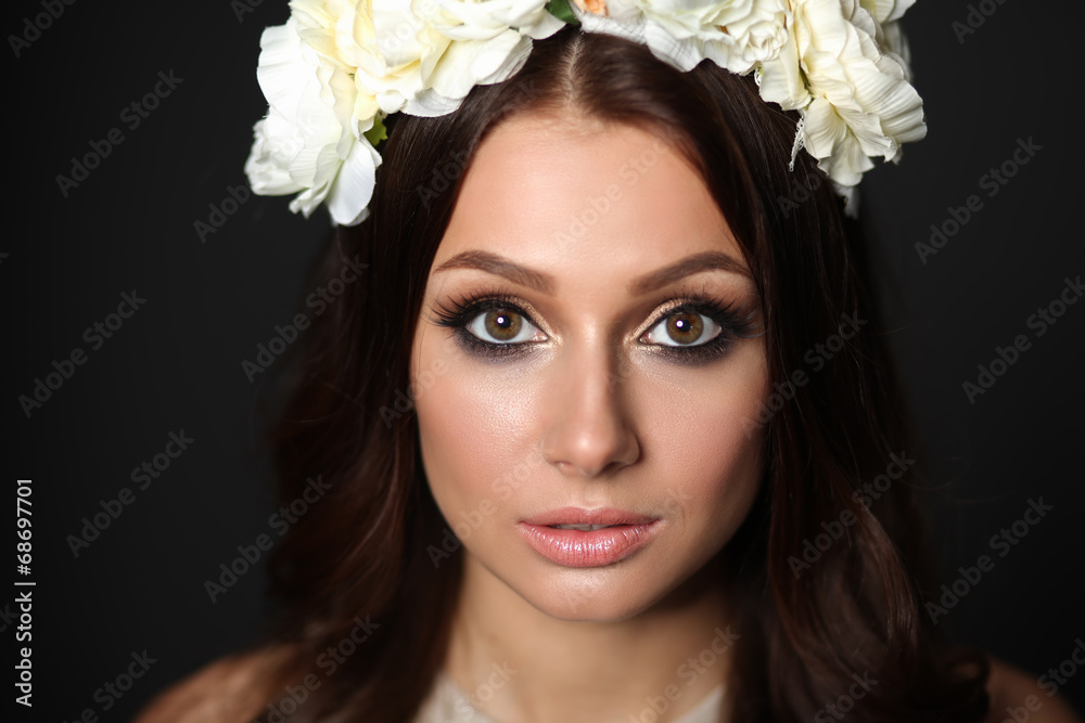 Portrait of a beautiful woman with flowers in her hair. Fashion