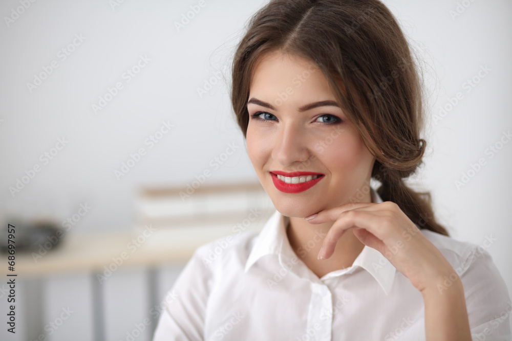 Attractive businesswoman sitting in the office Attractive businesswoman sitting in the office