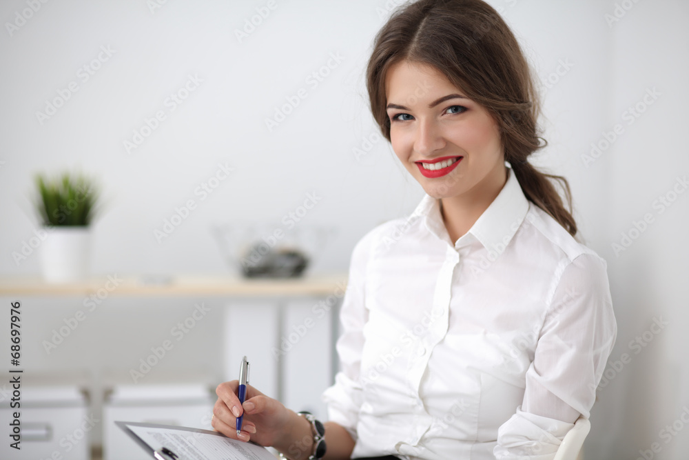 Portrait of a young woman working at office Portrait of a young woman working at office