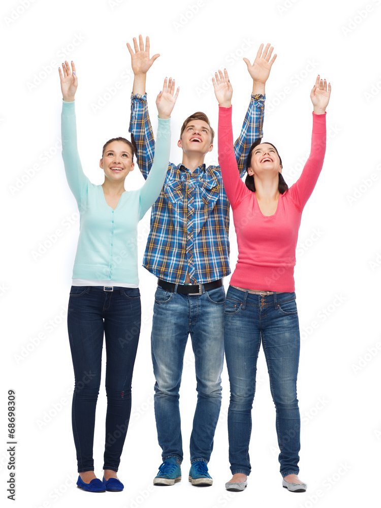 group of smiling teenagers with raised hands group of smiling teenagers with raised hands