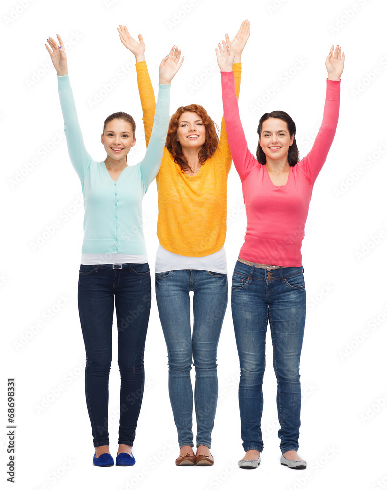 group of smiling teenagers with raised hands group of smiling teenagers with raised hands