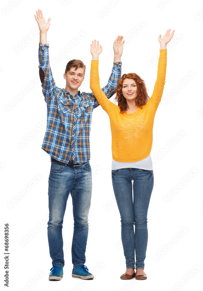 smiling teenagers with raised hands smiling teenagers with raised hands