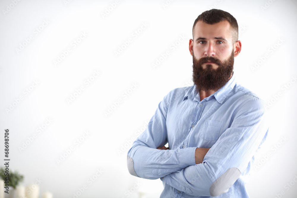 Portrait of a business man with hands folded standing in office Portrait of a business man with hands folded standing in office