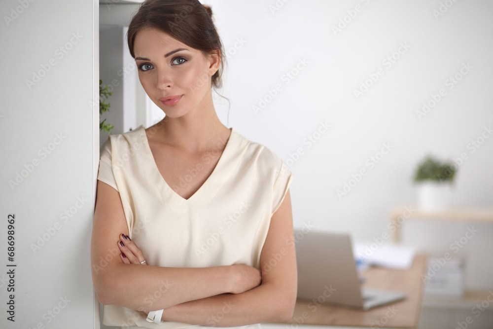 Close-up portrait of a smiling business woman standing in her Close-up portrait of a smiling business woman standing in her