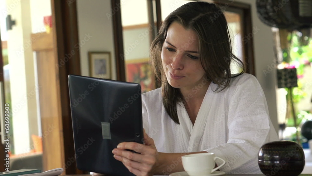 Woman with tablet computer sit by the table at home Woman with tablet computer sit by the table at home