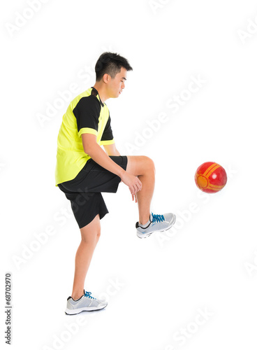 asian man playing soccer isolated on white background