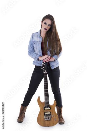 Gogeous blond rocker girl posing holding electric guitar