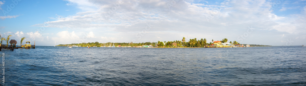 Colorful Caribbean buildings over the water with boats at dock Colorful Caribbean buildings over the water with boats at dock
