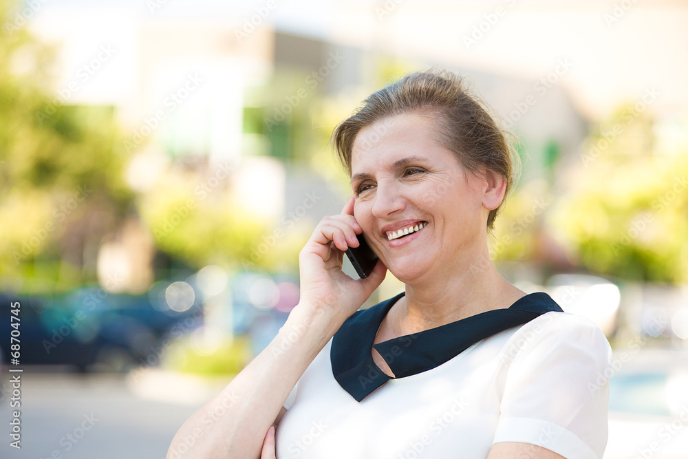Happy Woman Talking on a Phone outside street background Happy Woman Talking on a Phone outside street background