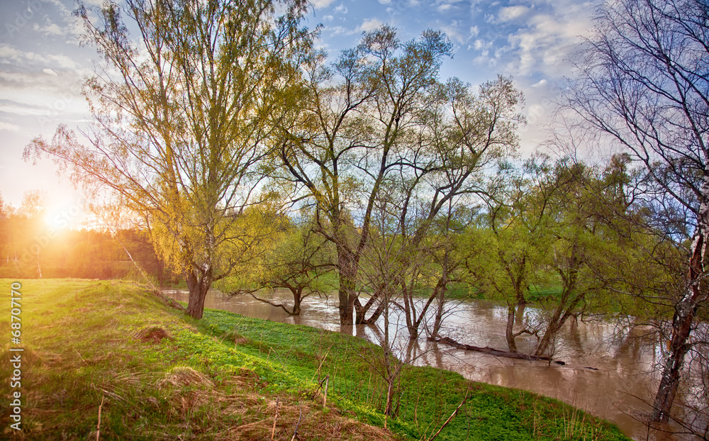 Spring panorama with the river in flood at sunset Spring panorama with the river in flood at sunset