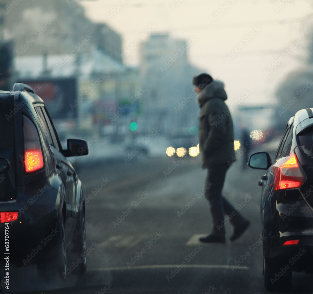 man crossing the road in the city