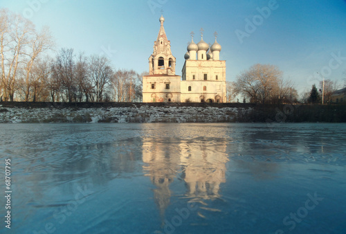 Church on the banks of the frozen river ice winter