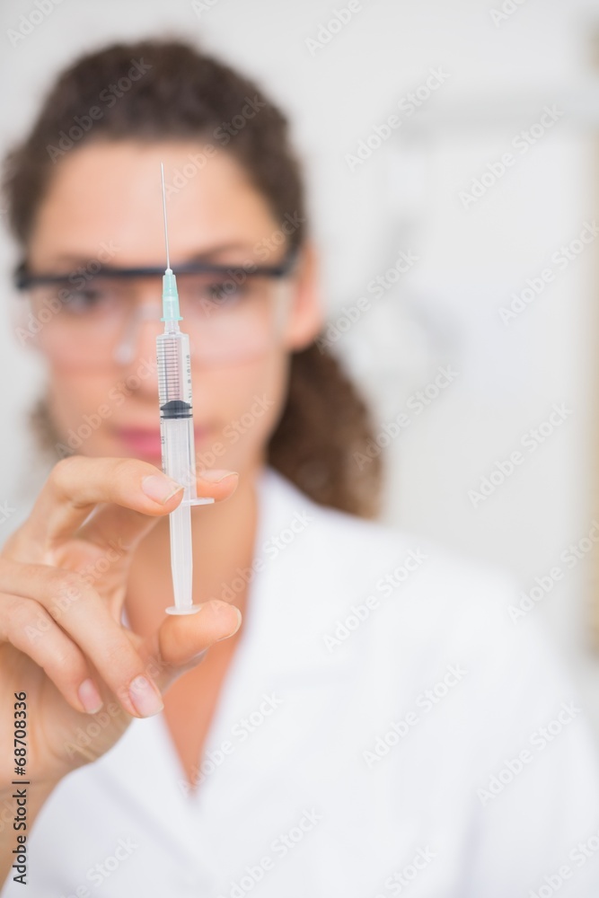 Dental assistant preparing an injection Dental assistant preparing an injection