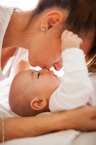 Mother kissing son's nose