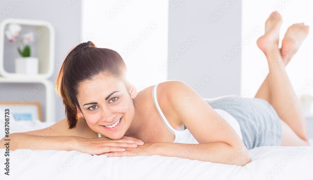 Smiling relaxed young woman lying in bed Smiling relaxed young woman lying in bed