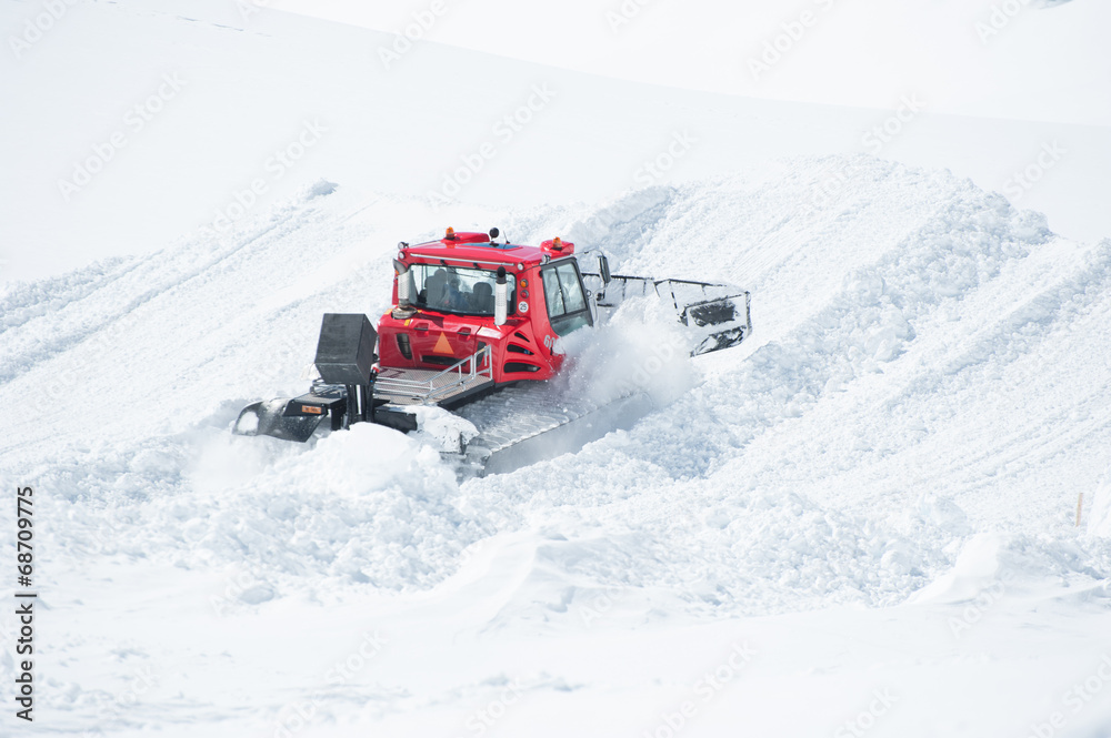 A Tracktor woking on snow field preparing for ski A Tracktor woking on snow field preparing for ski