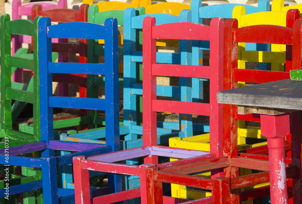 many chairs of different colors together
