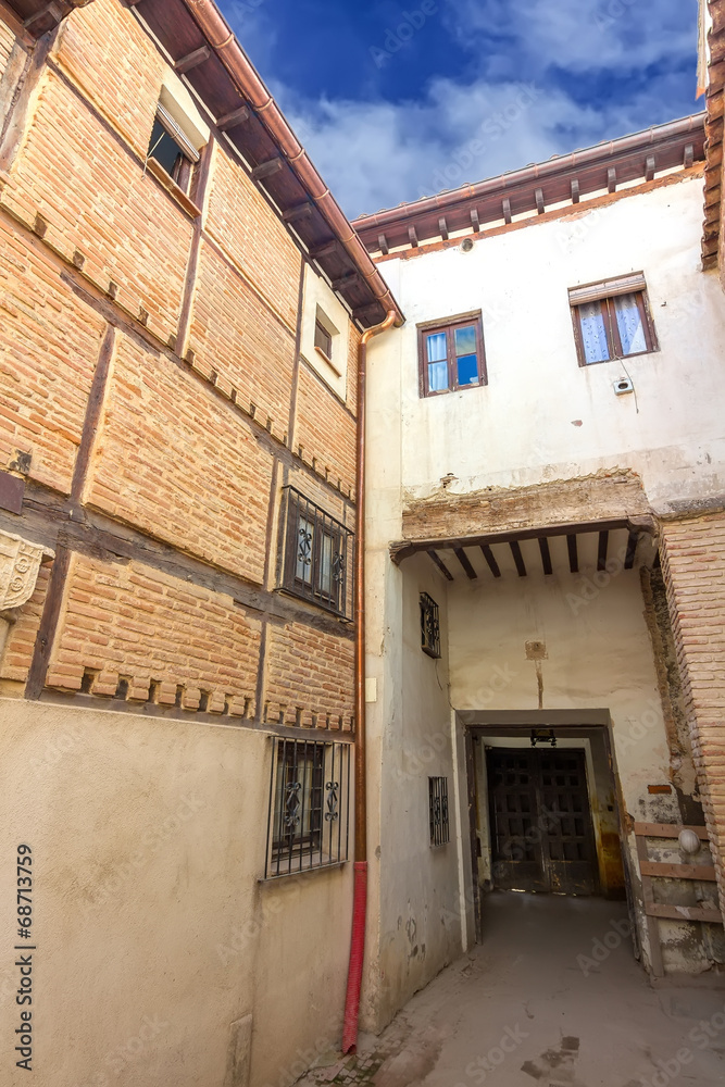 Spanish beautiful old building with white walls and wooden decki