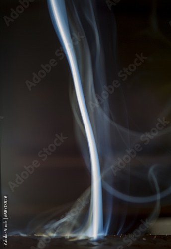 smoke of incense aromatic creating forms on a black background