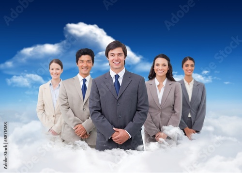 Composite image of smiling salesteam standing photo