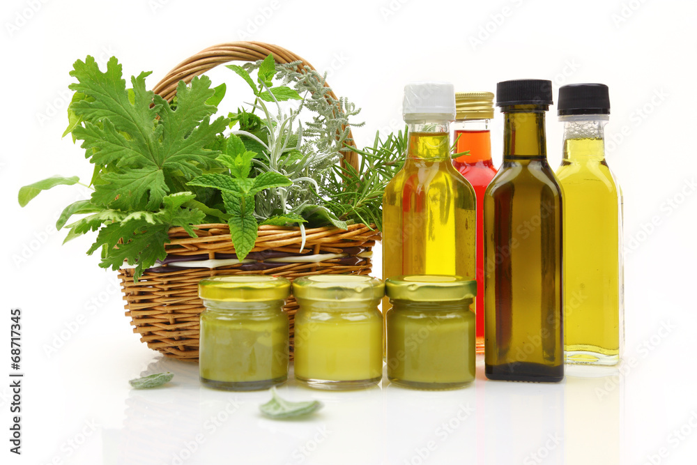 Fresh herbs in wicker basket and natural cosmetics