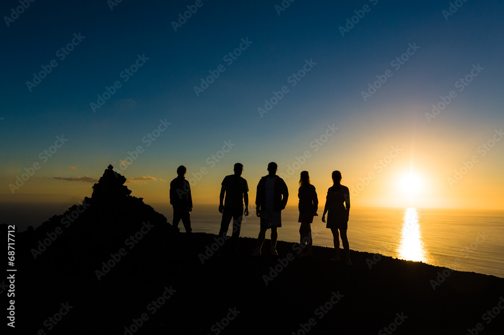 Group of travellers at sunset