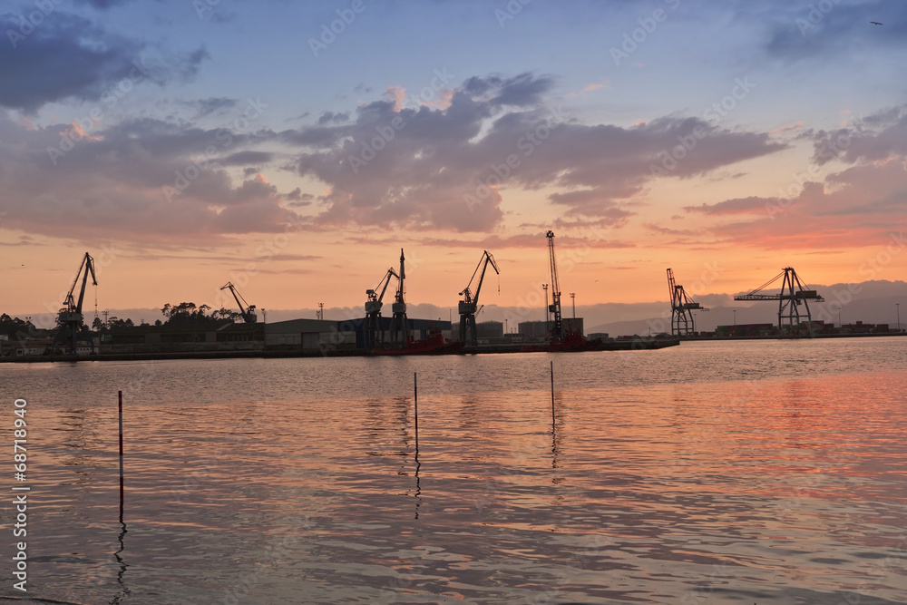 Harbor cranes at sunset