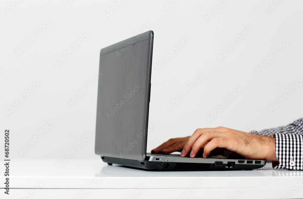 Closeup portrait of a male hands typing on the laptop