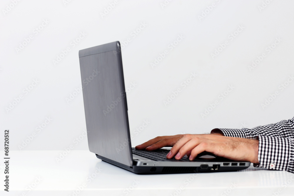 Closeup portrait of a male hands using on the laptop Closeup portrait of a male hands using on the laptop