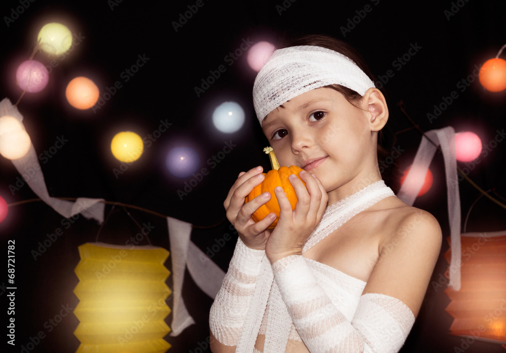 child wearing mummy costume holding halloween pumpkin child wearing mummy costume holding halloween pumpkin