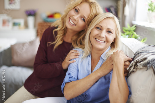 Portrait of blonde mother and daughter at home