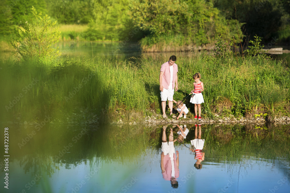 Happy father and daughters fishing