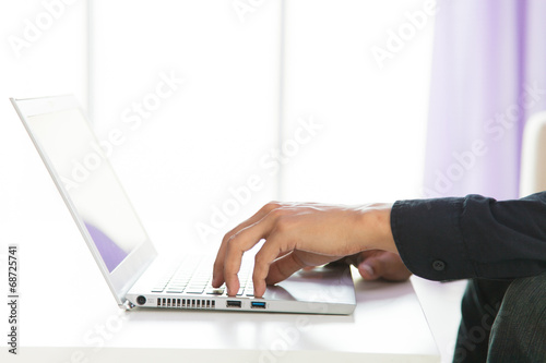 hands typing on laptop keyboard
