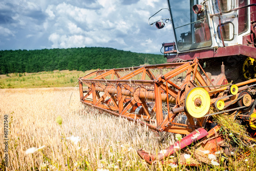 close-up of harvesting combine in wheat crops