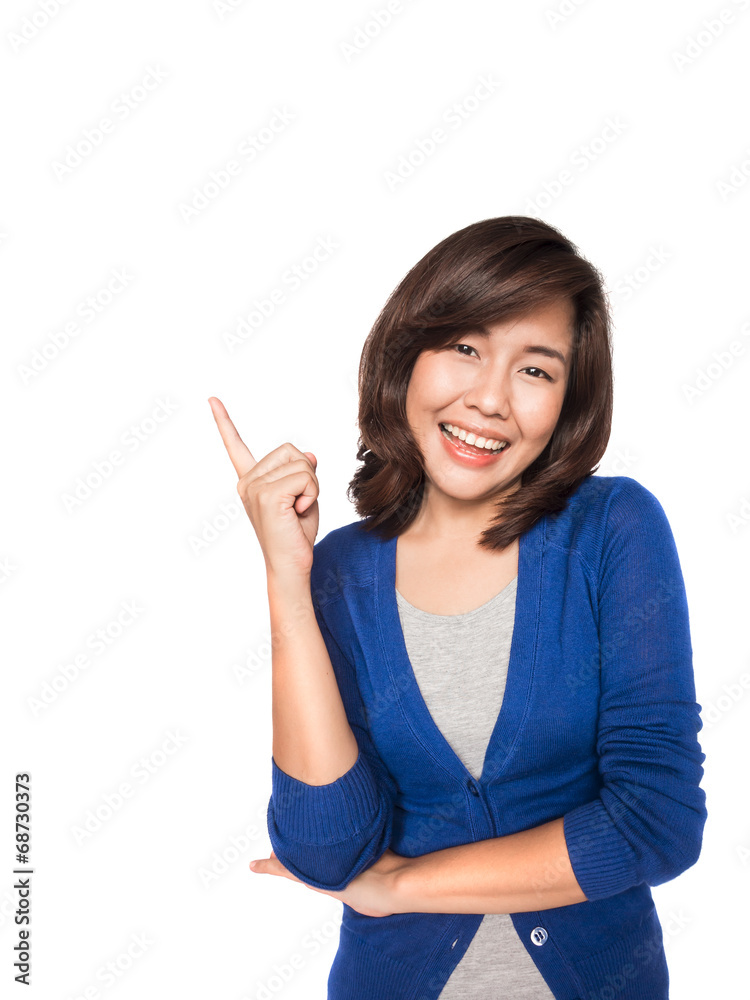 Woman smiling pointing up showing copy space. Woman smiling pointing up showing copy space.