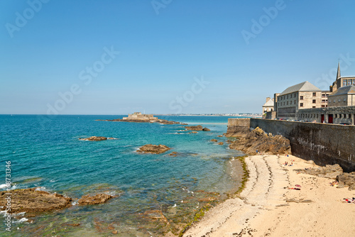 Beach of Saint Malo in summer with tourists and blue sky. Britta