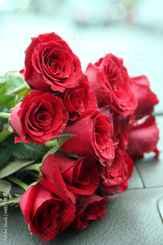 Red roses bouquet on car console