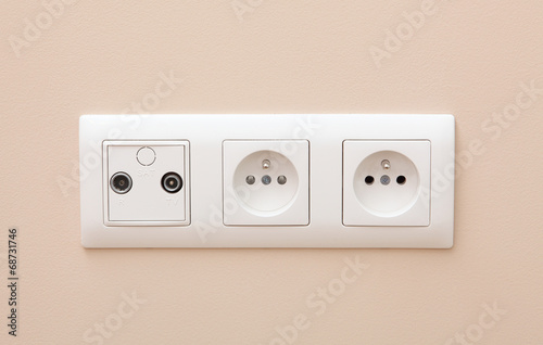 White electric socket on the wall.