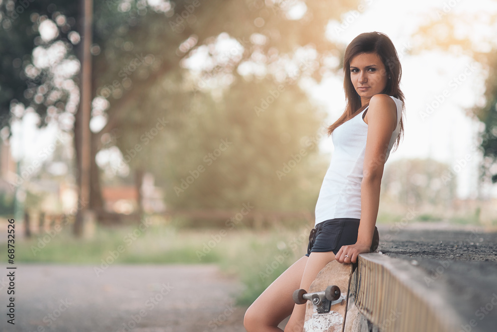 Beautiful skater girl in summer city Beautiful skater girl in summer city