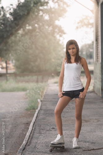 Beautiful skater girl in summer city © Creaturart