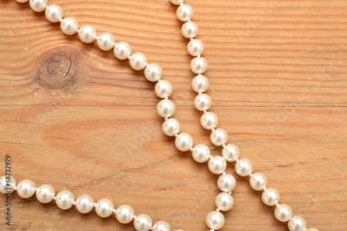 pearl necklace on wood