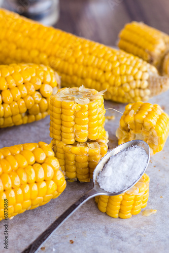 warm corn on the cob, sliced, teaspoon of salt