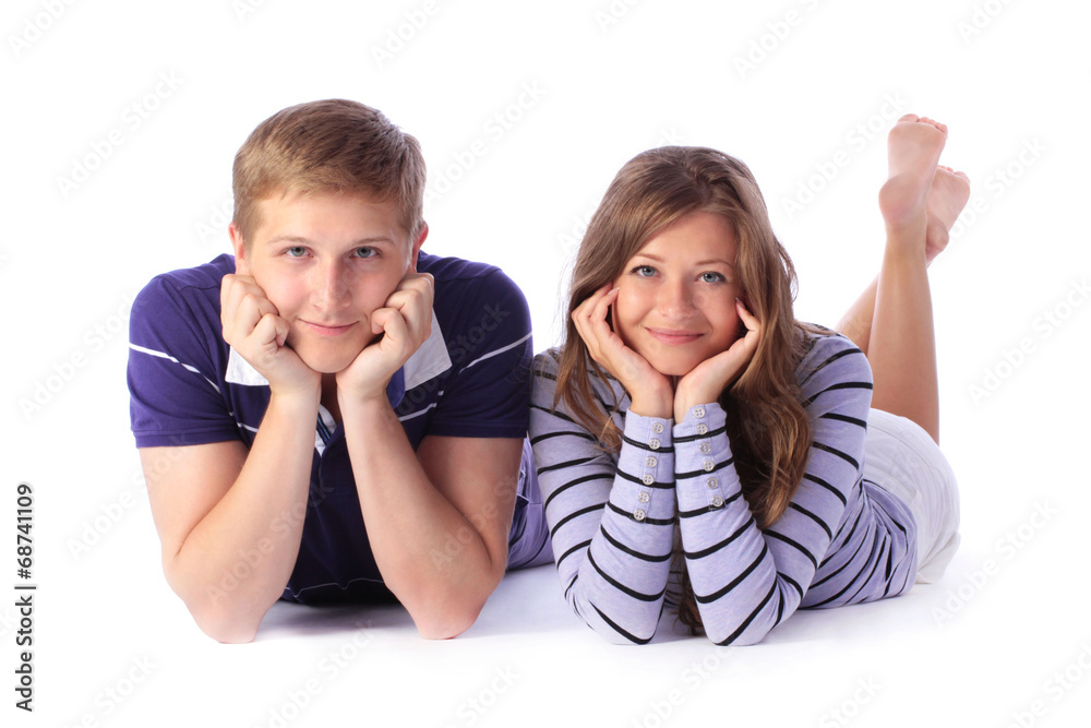 Happy young couple lying down on the floor