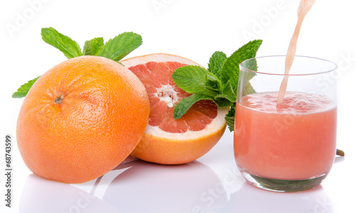Fototapeta Naklejka Na Ścianę i Meble -  Grapefruit juice poured into a glass