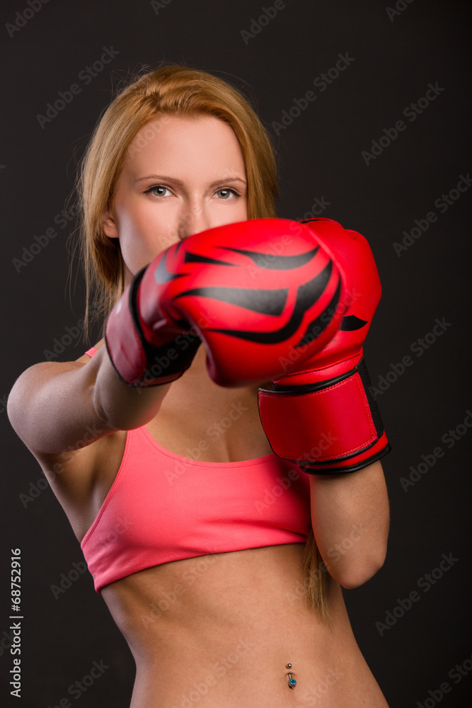beautiful woman with the red boxing gloves, dark background