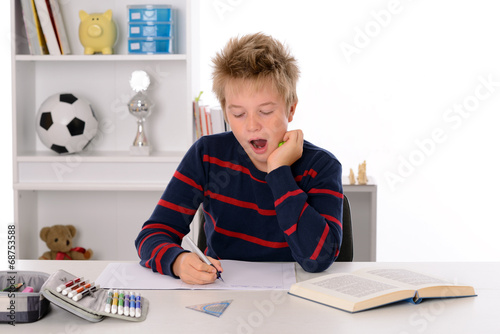 boy is tired at the homework