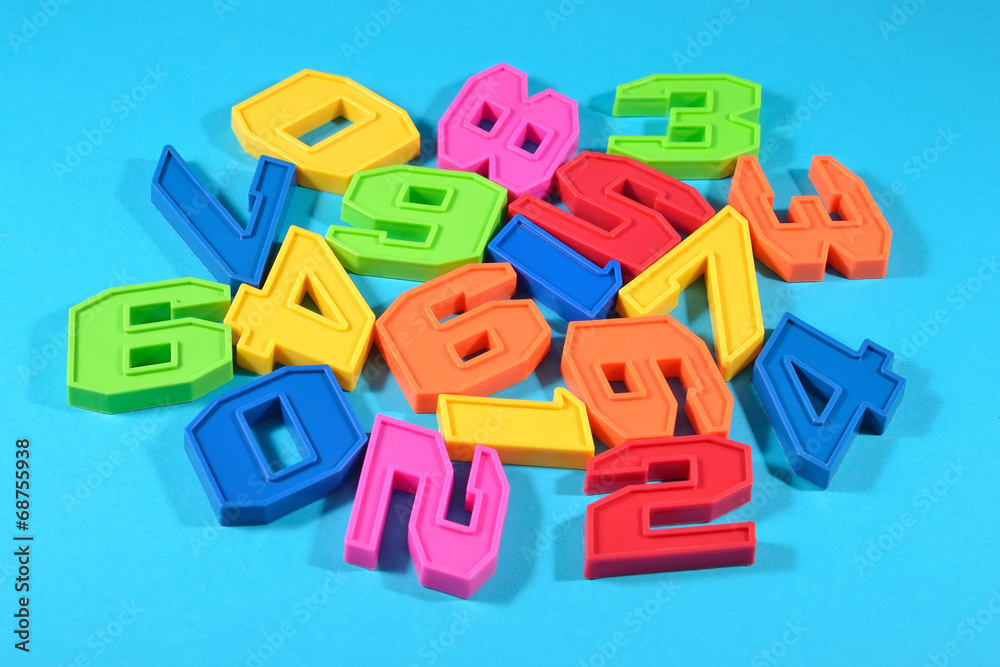 Plastic colored numbers on a blue background Plastic colored numbers on a blue background