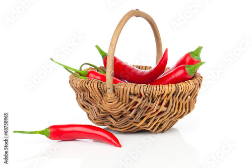 Red chili pepper in a wicker basket  isolated on white backgroun